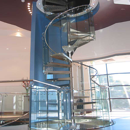 Spiral staircase with stainless steel rails and glass panels