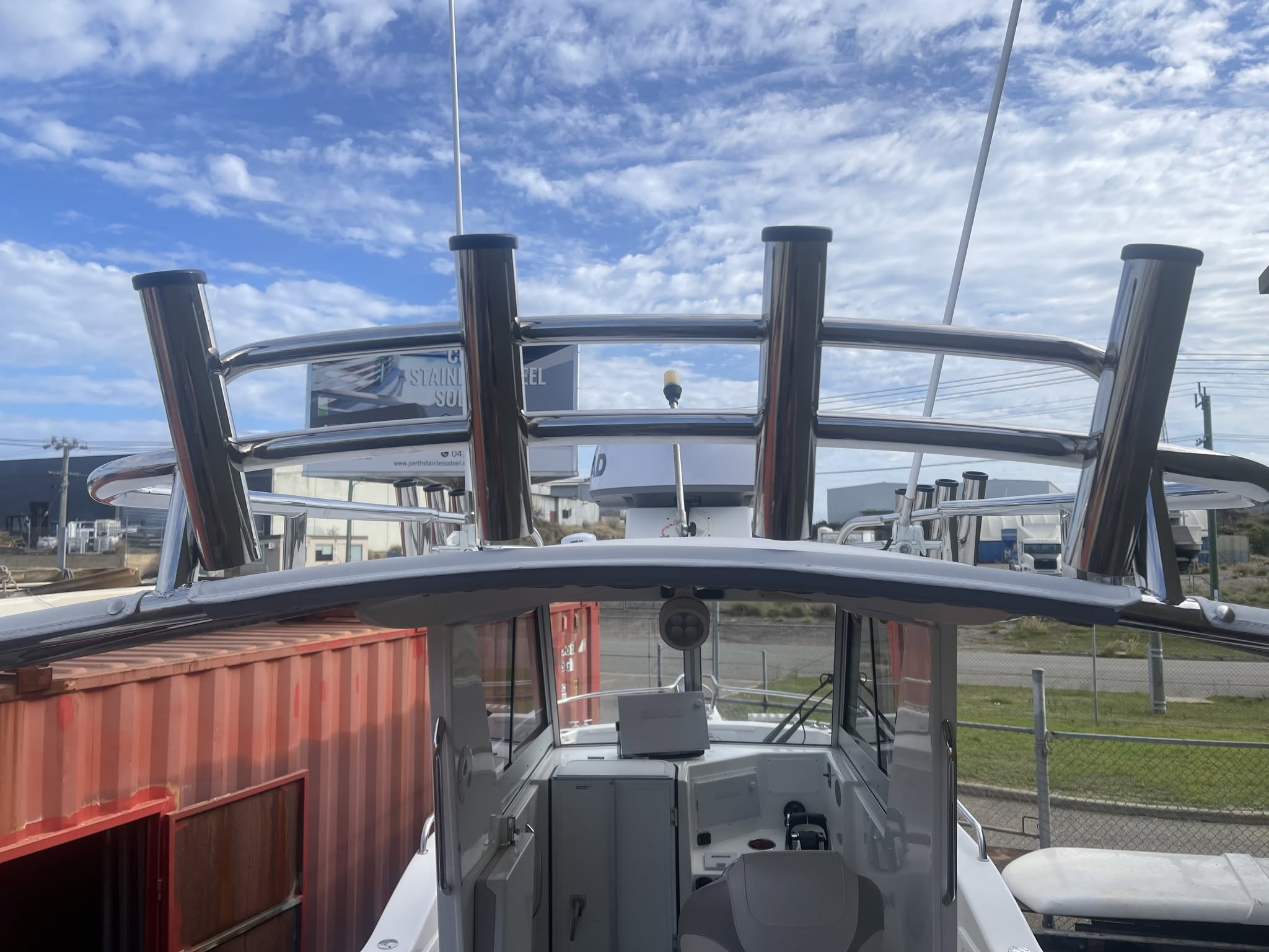 Stainless steel fishing rod holders mounted on a boat rail