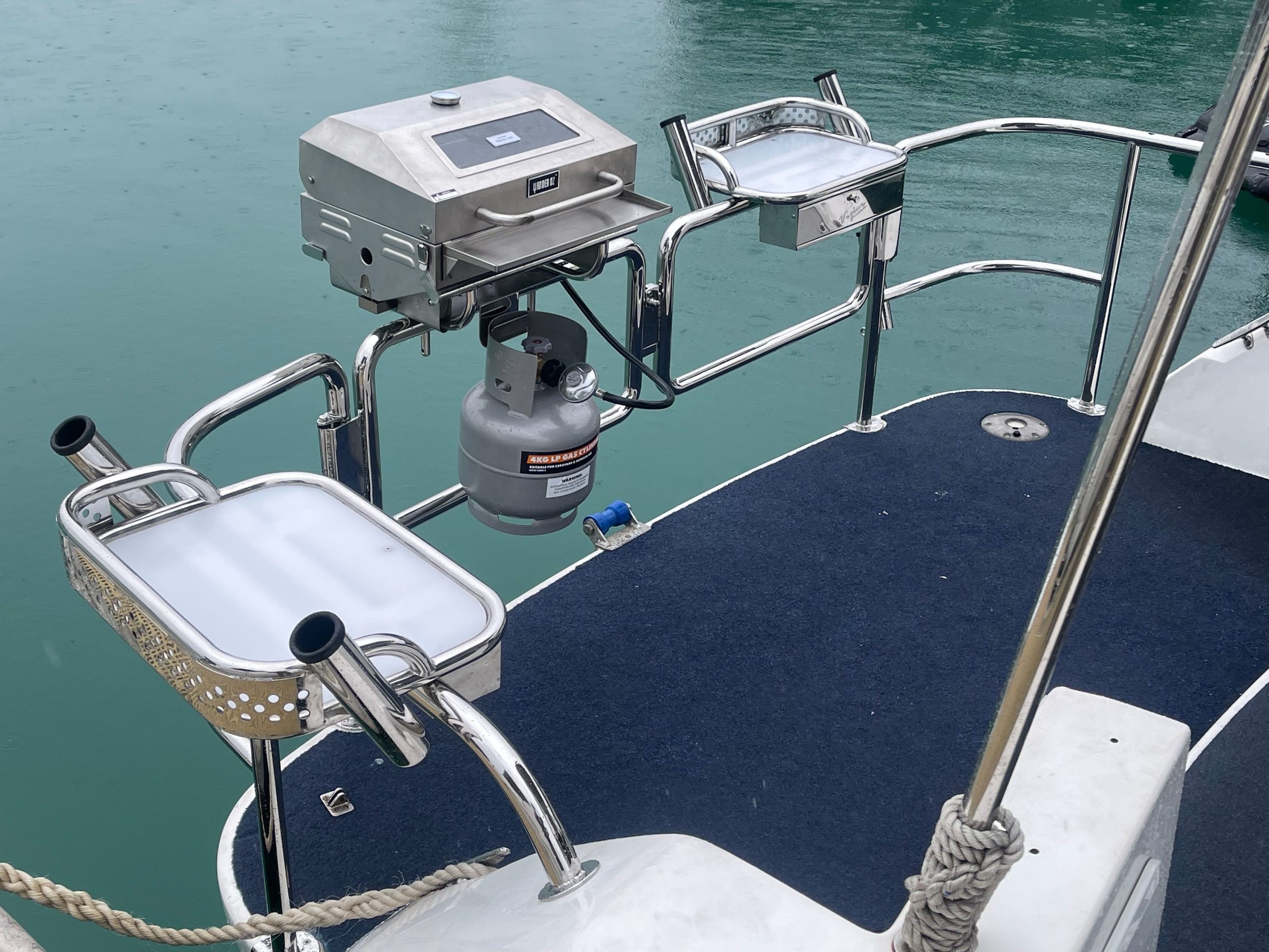 Custom stainless steel stern enclosure with BBQ and bait board on a boat in Coogee